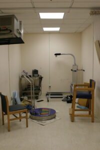 Photograph of John Gianutsos' office on January 20, 2008, the day that he died. The platform with the multicolored feet was a vibration platform that he got that was used in Japanese baseball. He used it to stimulate spasm in Spinal Cord Injury patients in order to maintain muscle tone.