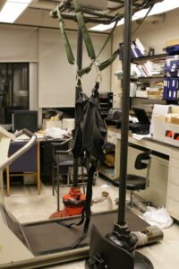 Photograph of John Gianutsos' office on January 20, 2008, the day that he died. The parachute harness was used to suspend paralyzed patients above a treadmill to induce involuntary motion in order to maintain muscle tone in paralyzed patients.